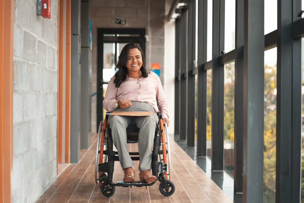 Businesswoman in a wheelchair using smartphone